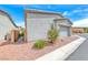 Home exterior with a two-car garage and desert landscaping at 669 Assurance Pl, Henderson, NV 89011