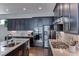 Kitchen with a stainless steel appliances, a stylish backsplash, and modern fixtures at 669 Assurance Pl, Henderson, NV 89011