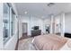 Well-lit main bedroom with hardwood floors, stylish furnishings, and an ensuite bathroom at 669 Assurance Pl, Henderson, NV 89011
