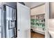 Well-organized pantry with ample shelving and storage baskets adjacent to a stainless steel refrigerator at 669 Assurance Pl, Henderson, NV 89011