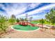 Fun community playground featuring a climbing structure, slide, and desert landscaping at 669 Assurance Pl, Henderson, NV 89011