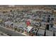 Aerial view of a neighborhood highlighting a home with a private pool, landscaping, and solar panels at 7058 W Camero Ave, Las Vegas, NV 89113