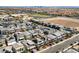 Residential neighborhood with modern homes, solar panels, and desert landscaping with city views in the distance at 7058 W Camero Ave, Las Vegas, NV 89113