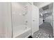 Bathroom featuring a shower/tub combo with tile surround and geometric tile flooring at 7058 W Camero Ave, Las Vegas, NV 89113