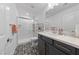 Elegant bathroom with sleek vanity, modern sink, and a walk-in shower, exuding contemporary style at 7058 W Camero Ave, Las Vegas, NV 89113