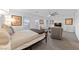 Comfortable bedroom with neutral tones, ceiling fan, and well-lit windows, creating a relaxing atmosphere at 7058 W Camero Ave, Las Vegas, NV 89113