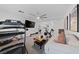 Bright bonus room with workout equipment, modern ceiling fan, television, and comfortable seating arrangement at 7058 W Camero Ave, Las Vegas, NV 89113
