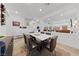 Bright dining room featuring stylish decor, modern lighting, and sleek furniture at 7058 W Camero Ave, Las Vegas, NV 89113