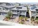 Two-story home with a three-car garage, solar panels, a brick driveway and mature landscaping at 7058 W Camero Ave, Las Vegas, NV 89113