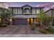 Charming two-story home with a paved driveway, stone accents, and manicured landscaping at 7058 W Camero Ave, Las Vegas, NV 89113