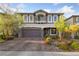 Charming two-story home featuring a well-manicured front yard and a spacious two-car garage at 7058 W Camero Ave, Las Vegas, NV 89113