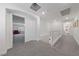 Upstairs hallway featuring neutral tones, carpeting, and entryways into bedrooms and bathrooms at 7058 W Camero Ave, Las Vegas, NV 89113