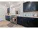 Close up of Kitchen featuring stainless steel appliances, dark cabinets, and designer countertops at 7058 W Camero Ave, Las Vegas, NV 89113