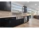 Modern kitchen with stainless steel sink, dark cabinets, designer countertops, and stainless appliances at 7058 W Camero Ave, Las Vegas, NV 89113