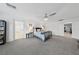 Spacious main bedroom with neutral carpet, a ceiling fan, and access to other rooms at 7058 W Camero Ave, Las Vegas, NV 89113