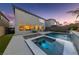 Backyard pool with a spa, waterfall feature, manicured lawn and the home's rear exterior at 7058 W Camero Ave, Las Vegas, NV 89113