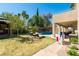 This gorgeous backyard has mature trees, an in-ground pool, and plenty of seating with patio cover at 723 Seclusion Glen Ave, Las Vegas, NV 89123