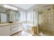 This bright bathroom features double sinks, tub, walk-in shower and large windows for plenty of natural light at 723 Seclusion Glen Ave, Las Vegas, NV 89123