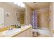 Bathroom featuring double sinks, tiled shower/tub, and neutral color scheme at 723 Seclusion Glen Ave, Las Vegas, NV 89123