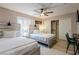 Bright bedroom with two beds, ceiling fan, closet and plank flooring at 723 Seclusion Glen Ave, Las Vegas, NV 89123