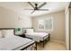 Cozy bedroom featuring two twin beds, ceiling fan, and window with plantation shutters at 723 Seclusion Glen Ave, Las Vegas, NV 89123
