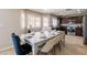 Dining area with elegant table setting, flowing into a modern kitchen with stainless appliances at 723 Seclusion Glen Ave, Las Vegas, NV 89123