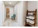 Hallway with wood-look flooring, linen shelves, and view into a bedroom at 723 Seclusion Glen Ave, Las Vegas, NV 89123