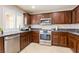 Modern kitchen features stainless steel appliances, granite counters, and stylish dark wood cabinets at 723 Seclusion Glen Ave, Las Vegas, NV 89123