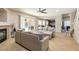 Open-concept living space with tile flooring, fireplace, and access to kitchen and backyard pool at 723 Seclusion Glen Ave, Las Vegas, NV 89123