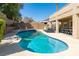 Backyard pool with lounge chairs and an outdoor dining area perfect for entertaining friends and Gathering at 723 Seclusion Glen Ave, Las Vegas, NV 89123