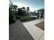 Lush backyard garden with blooming flowers and gravel pathway offers a serene outdoor space at 7451 Mystic Stream St, Las Vegas, NV 89131
