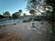 Serene backyard oasis featuring a tranquil fountain, garden, gravel ground cover, and inviting pool at 7451 Mystic Stream St, Las Vegas, NV 89131