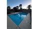 Sparkling swimming pool in backyard with mature palm trees provides a private oasis for relaxation and recreation at 7451 Mystic Stream St, Las Vegas, NV 89131