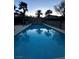 Inviting backyard pool with palm trees and a safety fence ensures relaxation and peace of mind at 7451 Mystic Stream St, Las Vegas, NV 89131