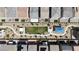 An aerial view highlights neighborhood layout with central park area and homes with solar panels at 7482 Lodano Ave, Las Vegas, NV 89113