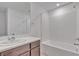 A bathroom features a shower-tub combination, a vanity and a large mirror at 7482 Lodano Ave, Las Vegas, NV 89113
