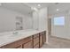 Well-lit bathroom featuring double sinks, granite countertops, and a glass-enclosed shower, for a spa-like experience at 7482 Lodano Ave, Las Vegas, NV 89113