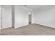 An empty carpeted bedroom includes doors to a closet and the ensuite bathroom at 7482 Lodano Ave, Las Vegas, NV 89113