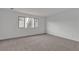 Spacious bedroom featuring a large window and plush carpeting, offering a serene and inviting atmosphere at 7482 Lodano Ave, Las Vegas, NV 89113