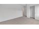 Bright bedroom featuring neutral carpet, white walls, and a closet for ample storage at 7482 Lodano Ave, Las Vegas, NV 89113