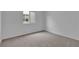 Cozy bedroom offering neutral carpet, a bright window, and fresh, neutral walls at 7482 Lodano Ave, Las Vegas, NV 89113