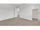 An empty carpeted bedroom includes doors to a closet and the ensuite bathroom at 7482 Lodano Ave, Las Vegas, NV 89113