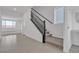 Bright entryway featuring tile floors, stairway with carpeted steps and modern black railings at 7482 Lodano Ave, Las Vegas, NV 89113