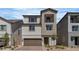 Charming two-story home featuring a balcony, a two-car garage, and meticulous landscaping, adding curb appeal to this lovely residence at 7482 Lodano Ave, Las Vegas, NV 89113