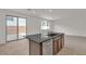 Kitchen island with granite countertops, stainless steel dishwasher, and sliding glass door access to yard at 7482 Lodano Ave, Las Vegas, NV 89113