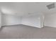Expansive living room with neutral carpeting and bright, neutral walls at 7482 Lodano Ave, Las Vegas, NV 89113