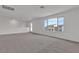 Bright, neutral carpeted living room with windows providing ample natural light and fresh, neutral walls at 7482 Lodano Ave, Las Vegas, NV 89113