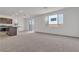 Open-concept living room with plush carpeting, contemporary recessed lighting, and sliding glass doors at 7482 Lodano Ave, Las Vegas, NV 89113