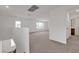 Spacious loft area with neutral carpeting, bright walls, and views of the neighborhood at 7482 Lodano Ave, Las Vegas, NV 89113