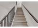 Close-up shot of a carpeted staircase with sleek black handrails, leading to the upper level at 7482 Lodano Ave, Las Vegas, NV 89113